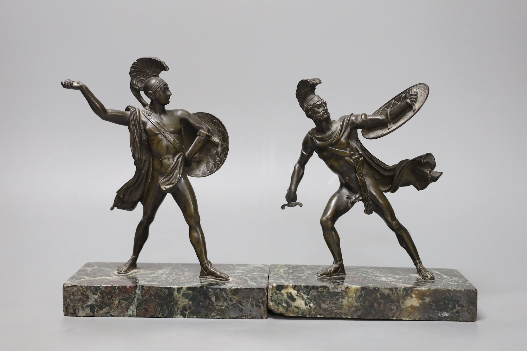 A pair of early 20th century bronze classical warriors, marble bases, tallest 21 cms high